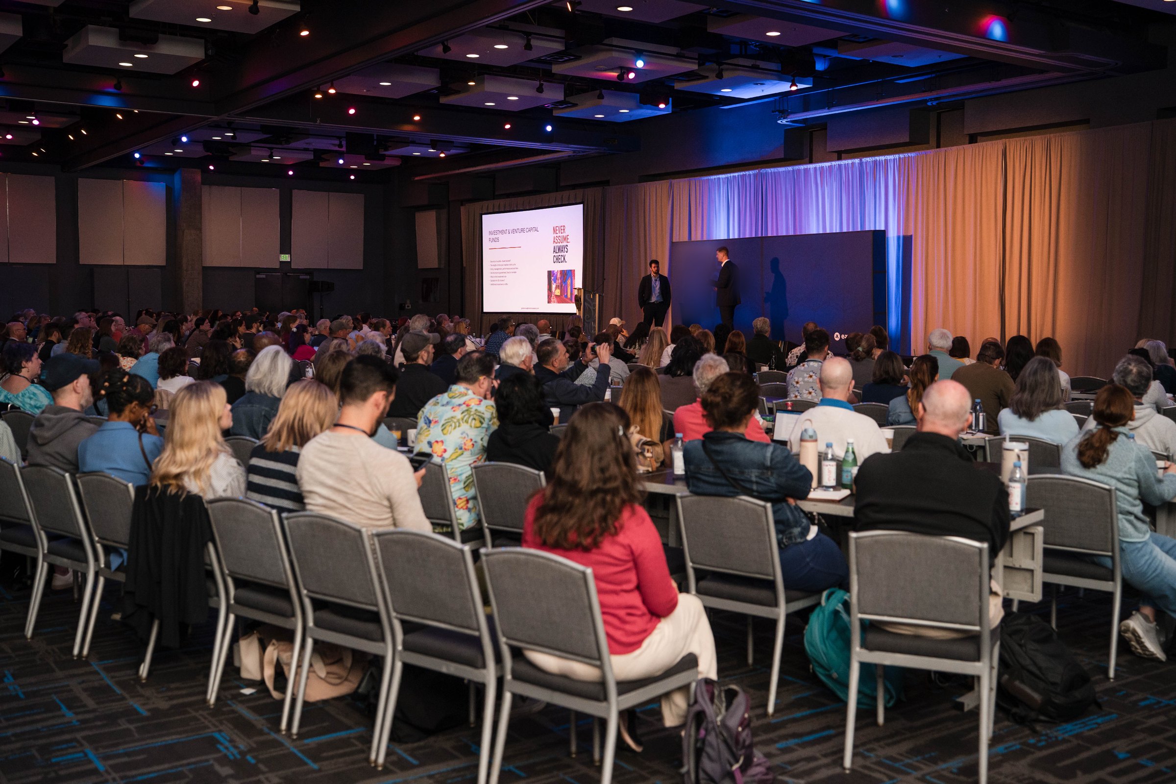 Jason Swan on stage before a full seminar audience