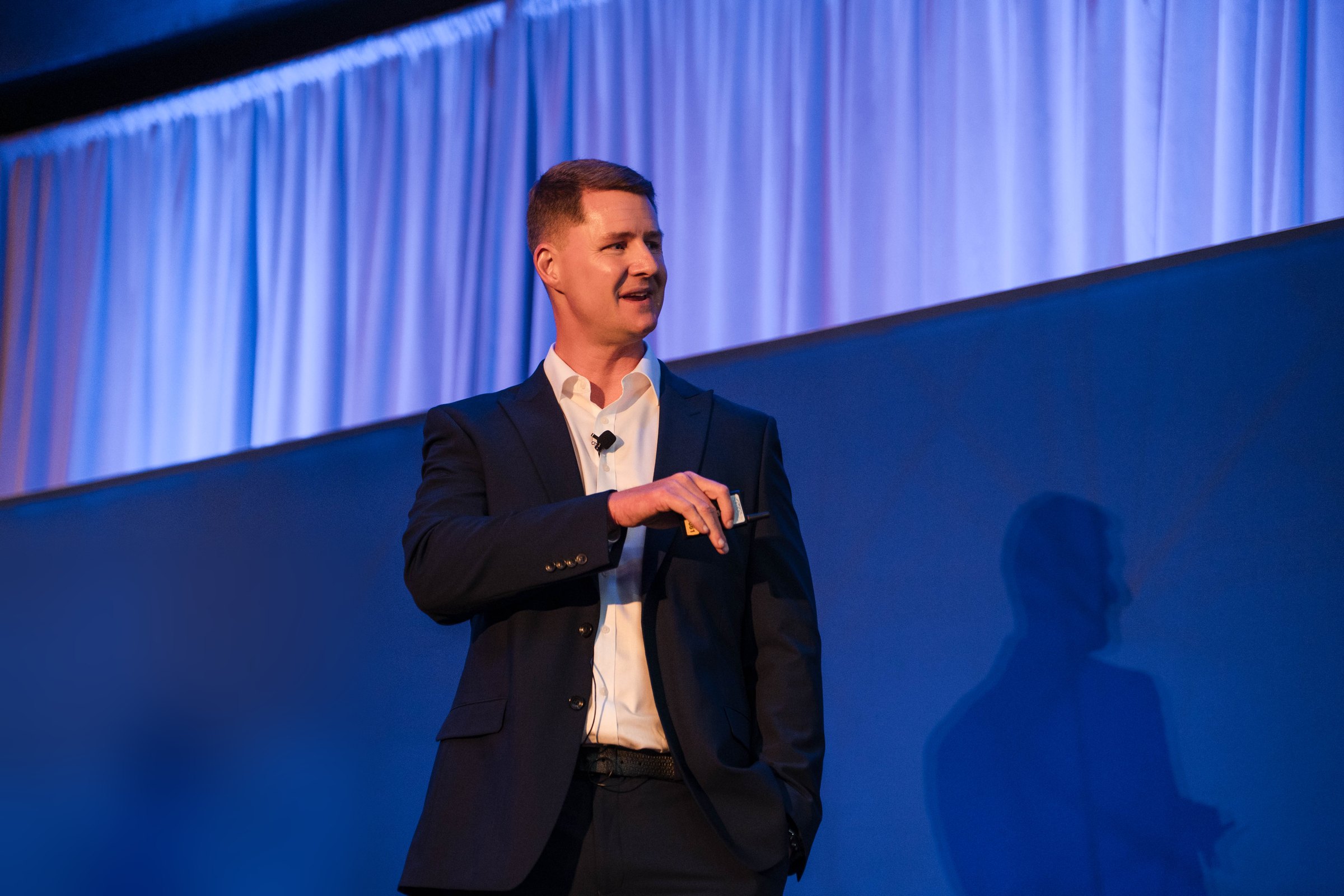 Jason Swan speaking on stage at a US seminar